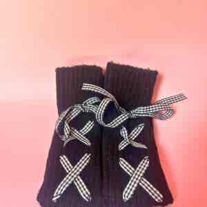 Black knitted leg warmers with gingham ribbon bows
